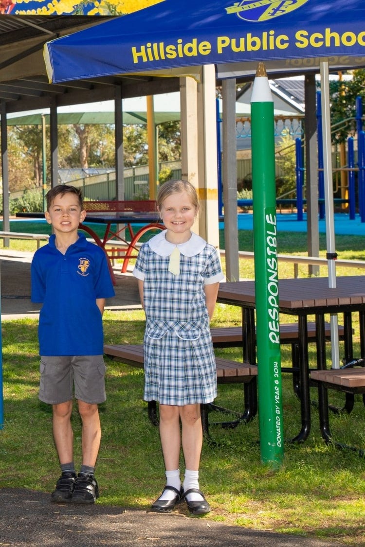 Hillside students smiling in front of picnic table area