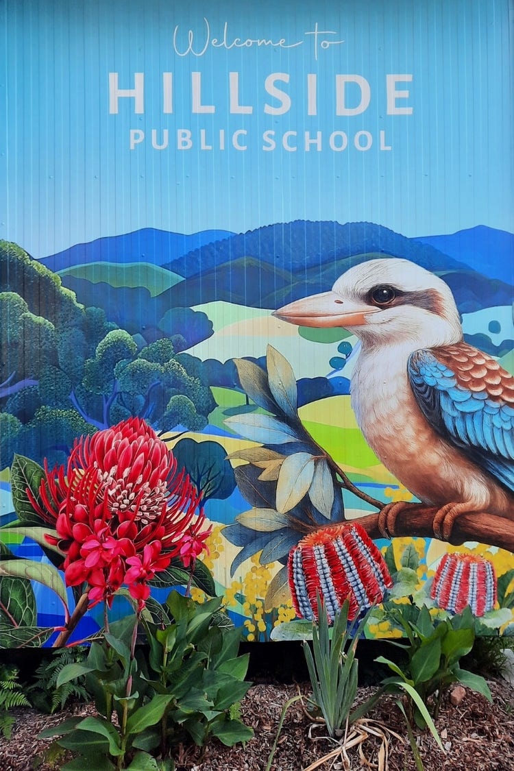 Welcome sign painted on office building that says