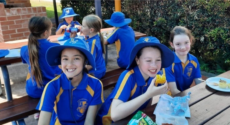 Hillside students eating canteen food at the recess and lunch benches.
