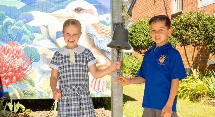 Hillside students ringing school bell.