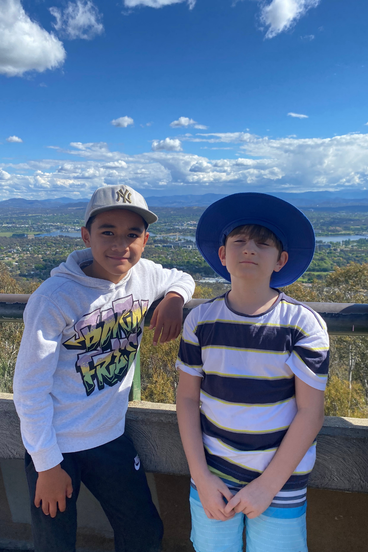 Hillside students smiling whilst standing at lookout at Mount Ainslie